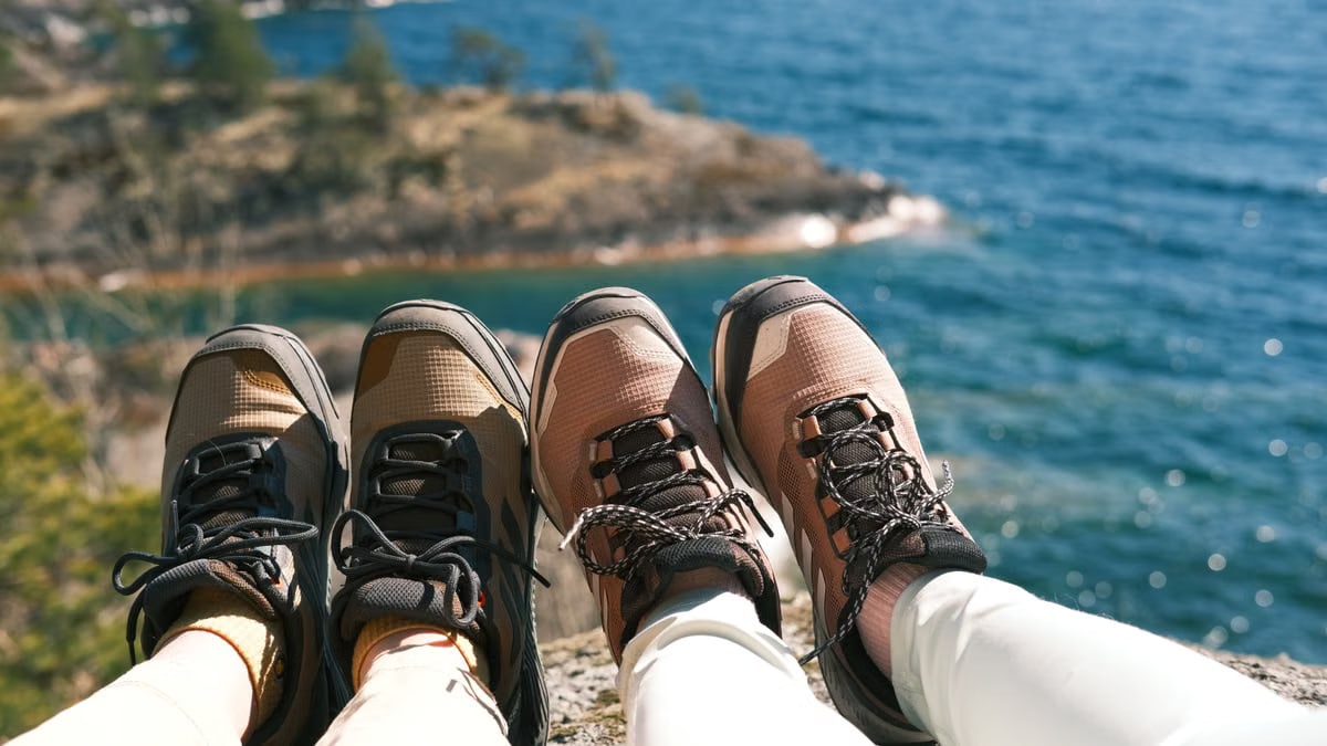 Two hikers rest with a scenic view of a lake in Örebro County, Sweden.